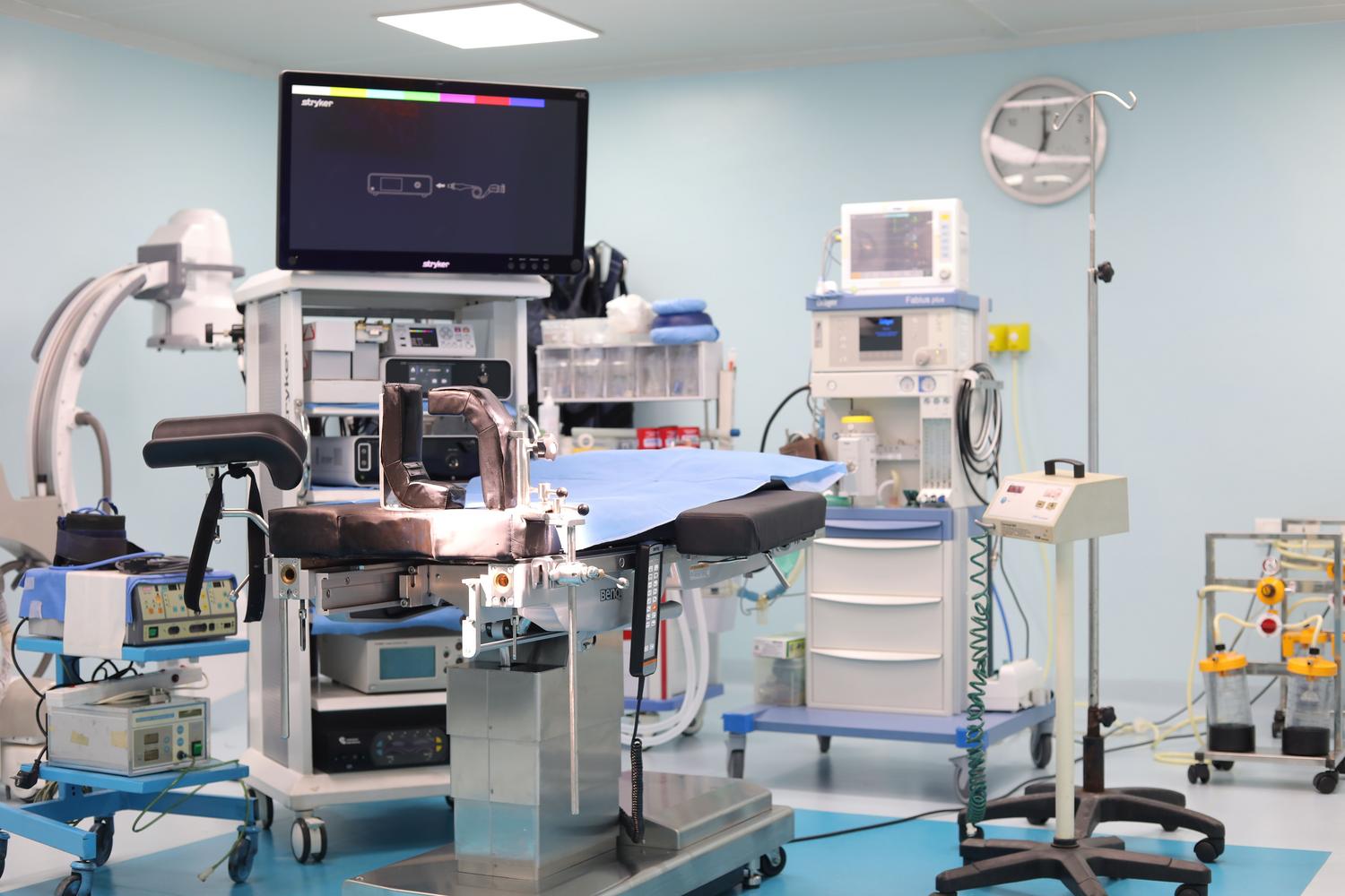 Vista general de um quirófano moderno e estéril com tecnologia médica avançada.